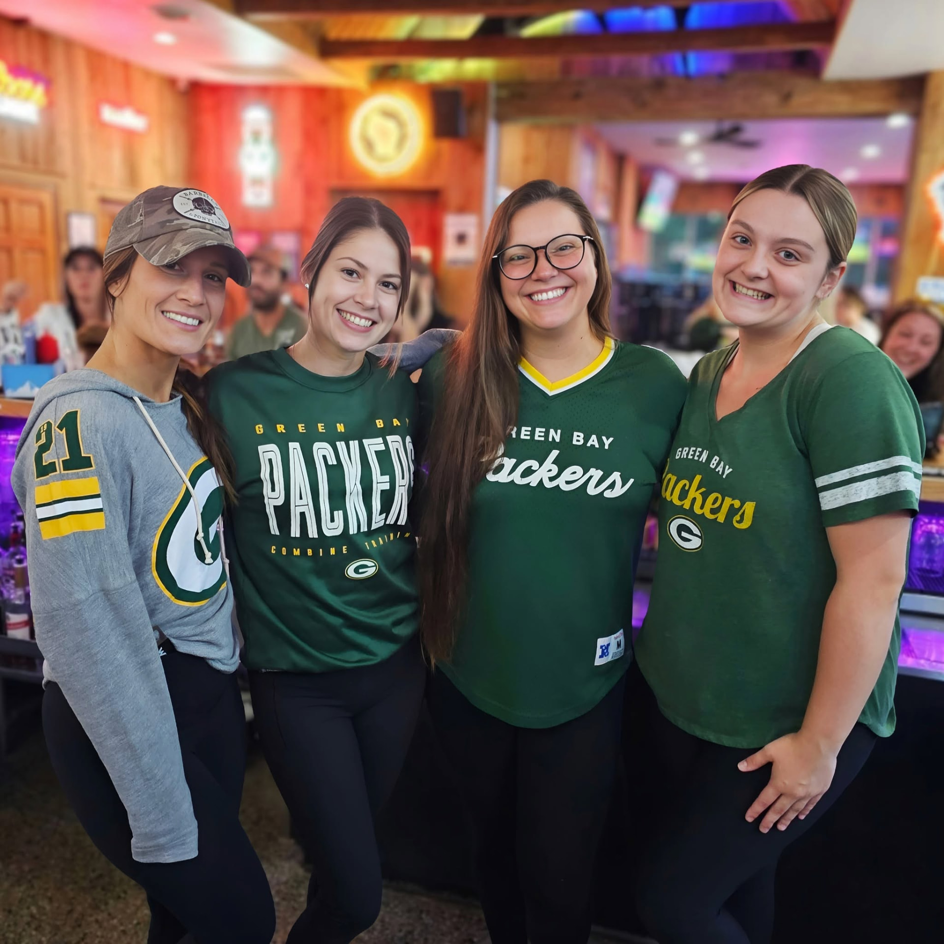 A group in Green Bay Packers jerseys at Sunset Bar & Grill
