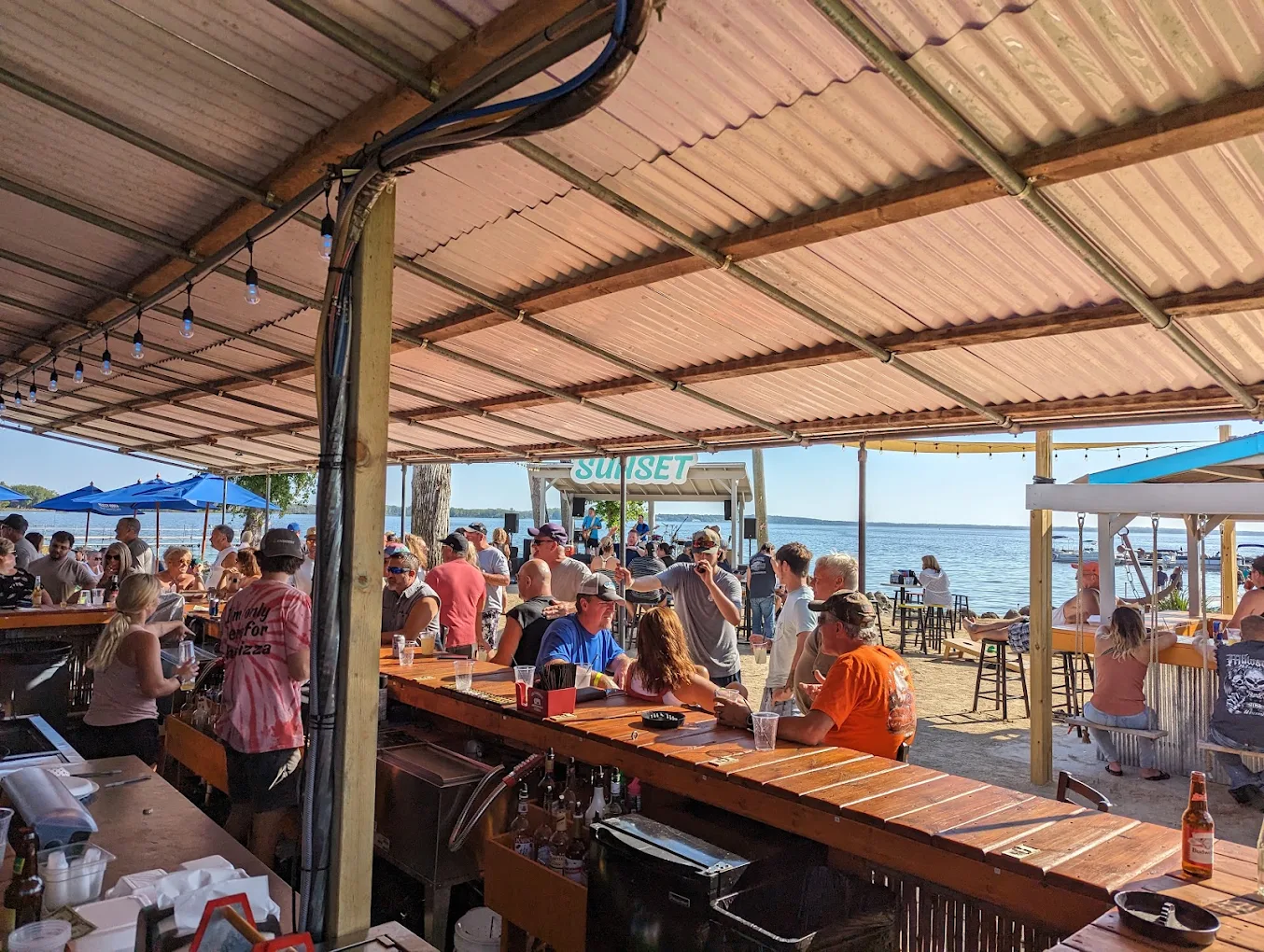 Friends at the lakefront tiki bar at Sunset Bar & Grill on Lake Koshkonong